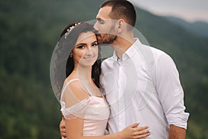 Close up portrait of beautiful couple in mountains. Happy woman with man. Elegant female with her husband