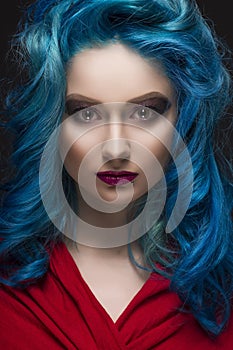 Close-up portrait of beautiful dyed blue colour hair girl wearing red scarf