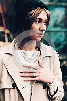 Close-up portrait Beautiful elegant woman wearing beige coat and black hat. Trendy casual outfit. Soft selective focus. grain