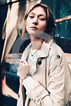 Close-up portrait Beautiful elegant woman wearing beige coat and black hat. Trendy casual outfit. Soft selective focus. grain