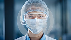 Close Up Portrait of a Beautiful Female Doctor or Surgeon Wearing a Protective Face Mask, Goggles