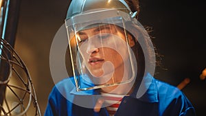 Close Up Portrait of Beautiful Female Fabricator in Blue Jumpsuit and Safety Mask. She is Grinding