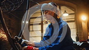 Close Up Portrait of Beautiful Female Fabricator in Safety Mask. She is Grinding a Metal Object an