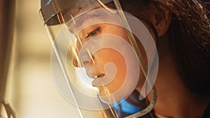 Close Up Portrait of Beautiful Female Fabricator in Safety Mask. She is Grinding a Metal Object. E