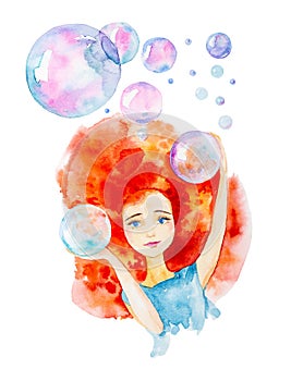 Close-up portrait of a beautiful girl in a blue dress with red hair and blue eyes.Surrounded by big soap bubbles.Catches them with