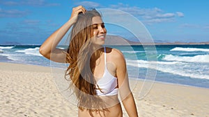 Close up portrait of beautiful girl have fun on Corralejo Dunas beach in Fuerteventura, Canary Islands photo