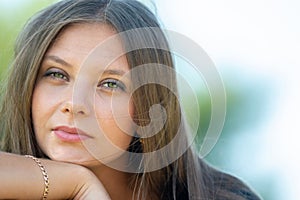 Close-up portrait of a beautiful girl of Slavic appearance, the girl squints into the frame