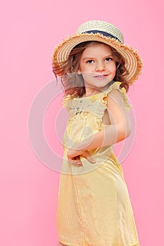 Close up portrait of a Beautiful girl in yellow dress and straw hat.