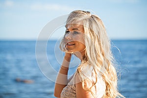 Close-up portrait of a beautiful happy young woman on a sea beach. Summer vacation concept