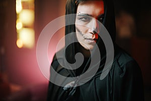 Close-up portrait of a beautiful man`s face with Halloween make-up.