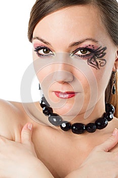 Close up of portrait of beautiful model woman with stylish creative makeup and body art butterfly on white background.