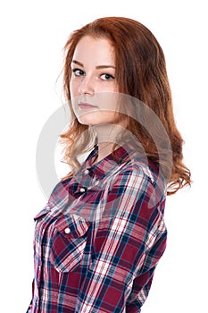 Close-up portrait of a beautiful red-haired girl looking at the camera