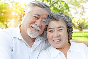 Close up portrait beautiful senior couple hugging, posing in spring park with happy, smile faces. Grandfather and grandmother rela