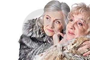 Close-up portrait of beautiful senior women in fur coats