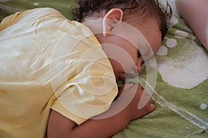 close-up portrait of a beautiful sleeping baby on bed. New family and baby protection from mom concept