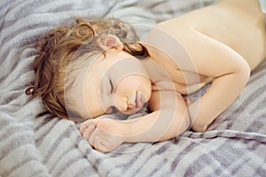 Close-up portrait of a beautiful sleeping baby. Cute infant kid. Child portrait in pastel tones. The baby could be a boy or girl