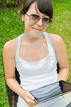 Close up portrait of a beautiful smile young girl with a tablet