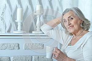 Portrait of beautiful smiling senior woman drinking tea