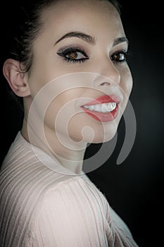 Close up portrait of a beautiful smiling young woman with curly black hair and red lipstick