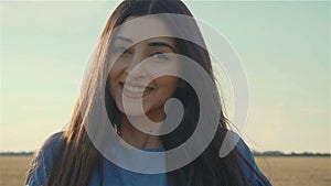 Close up portrait of beautiful woman enjoying peaceful sunset and exploring spirituality with wind blowing hair