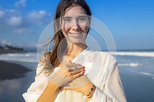 Close up portrait of beautiful woman with jewelry. Happy Caucasian woman at the beach. Beauty and fashion concept. Travel