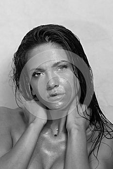 Close-up portrait of beautiful woman& x27;s purity face. Model with wet clean shiny skin.