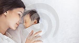 Close up portrait of beautiful young asian or caucasian mother with her healthy newborn baby.