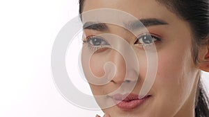Close up portrait of beautiful young asian woman touching face and healthy skin in slow motion skincare concept.