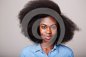 Close up portrait of beautiful young black woman with afro hair staring