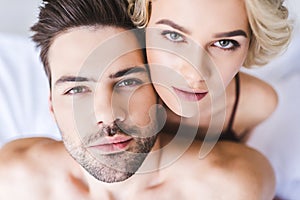 close-up portrait of beautiful young couple looking at camera