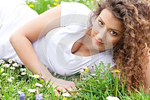 Close up portrait of beautiful young girl in flower field