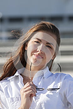 Close up portrait of beautiful young happy brunette woman with fresh skin, summer street outdoors