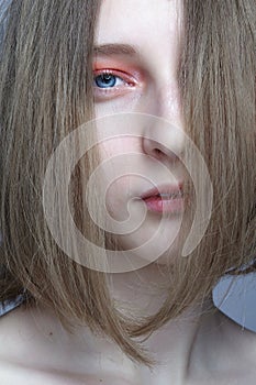 Close-up portrait of beautiful  young woman with blond hair covering her face
