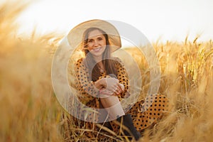 Close-up portrait of beautiful young woman in a countryside field. Female face in the rays of sunset. Freedome and