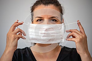 Close up portrait of beautiful young woman cover her face wearing  medical  mask