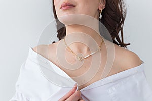 Close-up portrait of beautiful young woman with elegant hairstyle and luxurious jewelry and bijouterie.