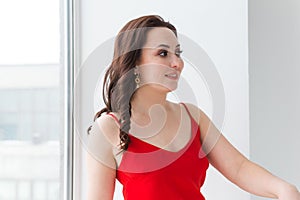 Close-up portrait of beautiful young woman with elegant hairstyle and luxurious jewelry and bijouterie.