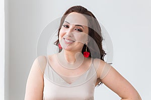 Close-up portrait of beautiful young woman with elegant hairstyle and luxurious jewelry and bijouterie.