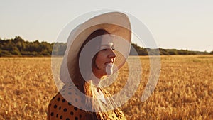 Close-up portrait of beautiful young woman in a field. Female face in the rays of sunset. Freedome and happiness concept