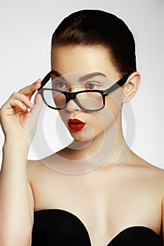Close-up portrait of beautiful young woman in glasses. Face expr