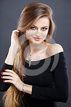 Close-up portrait of beautiful young woman with luxury jewelry and perfect make up