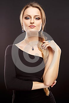 Close-up portrait of beautiful young woman with luxury jewelry and perfect make up