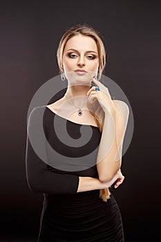 Close-up portrait of beautiful young woman with luxury jewelry and perfect make up