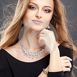 Close-up portrait of beautiful young woman with luxury jewelry and perfect make up