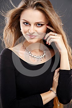 Close-up portrait of beautiful young woman with luxury jewelry and perfect make up