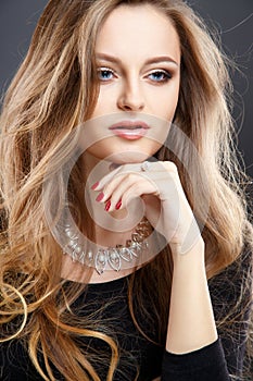 Close-up portrait of beautiful young woman with luxury jewelry and perfect make up