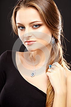 Close-up portrait of beautiful young woman with luxury jewelry and perfect make up