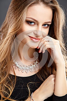 Close-up portrait of beautiful young woman with luxury jewelry and perfect make up