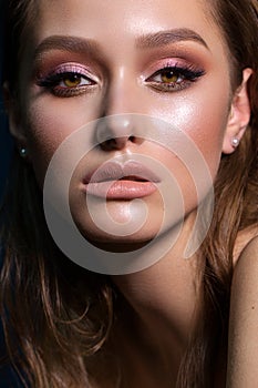 Close up portrait of beautiful young woman with professional makeup, perfect skin, colorful eyeshadows.