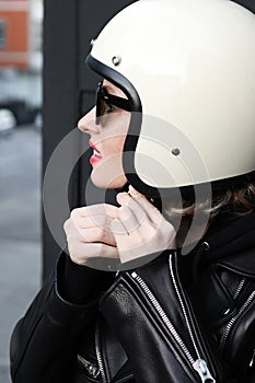 Close-up portrait of biker girl wearing white helmet.